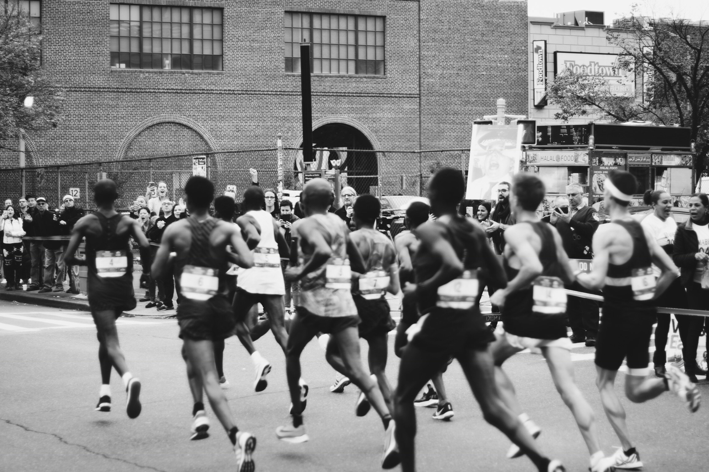 background image of runners in a 5k road race